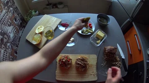 Add pickles cucumber to a pulled pork burgers with female hands on the kitchen Stock Footage 64666920