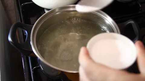 Add salt in boiling water Stock-Footage 83033954
