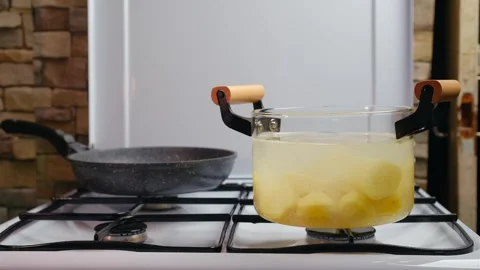 Add salt, pepper and bay leaf to pot with boiling potato Stock Footage 250444009