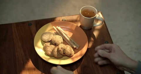 Add some sweets to your morning drink. Cup of drink and cookies. Stock Footage 128317654