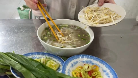 Add sprouted beans, wheat, and mung beans to Vietnamese pho soup Stock Footage 270076837