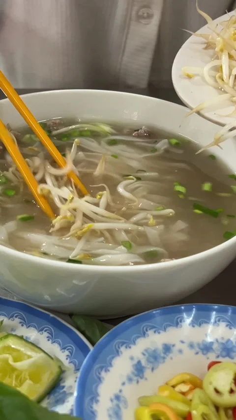 Add sprouted beans, wheat, and mung beans to Vietnamese pho soup Stock Footage 270078648