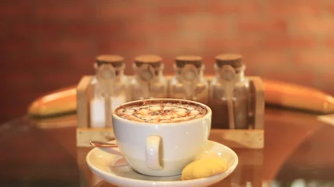 Add sugar to sweetened coffee in a cup. Stock Footage 98965744