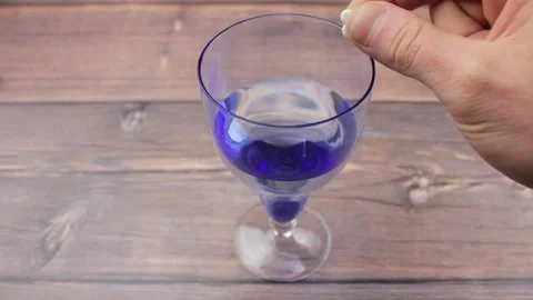 Add tablets to a glass of water. Throw the tablets into the water. Stock Footage 176965623