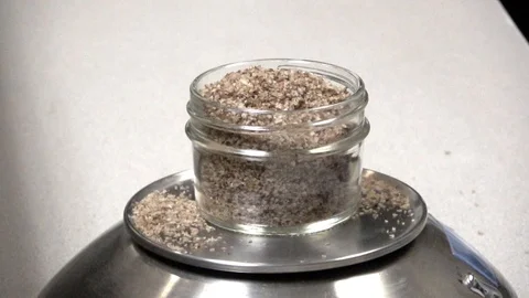 Add a tiny bit more spice to jar on scale measuring weight Video stock 100438494