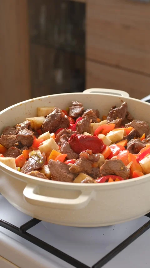Add tomato paste into a pot with beef stew Stock Footage 321278665