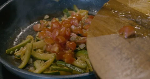 Add tomatoes into a pan Stock Footage 251826780