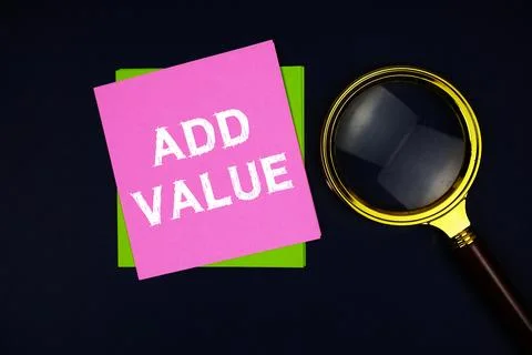 Add Value text on sticky note with magnifying glass on black background 写真素材