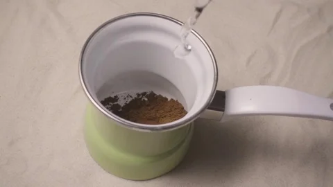 Add water to the briki cezve with coffee slow motion Stock Footage