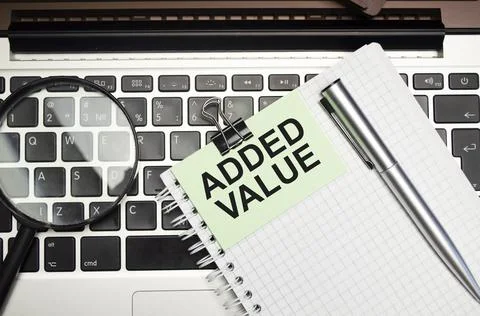 ADDED VALUE text on the white paper. Business concept Stock Photos