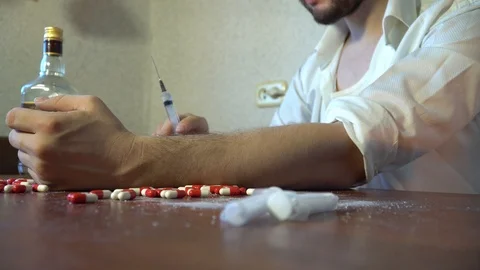 Addict colitis syringe in hand Stock Footage 86044932