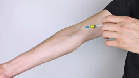 The addict makes himself an injection of prohibited preparation into the veins o Stock Footage 141847907