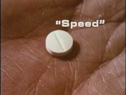 An addict on speed experiences a racing heart and paramedics load an inebriated Video stock 74936064