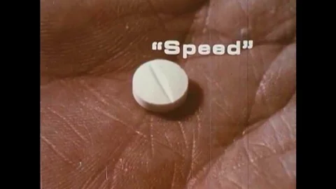 An addict on speed experiences a racing heart and paramedics load an inebriated Stock Footage 137249587