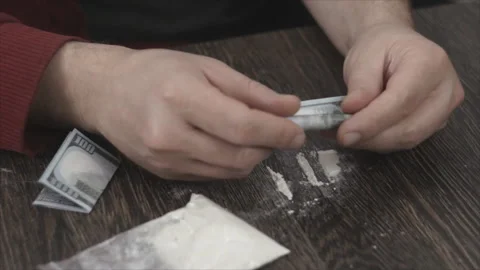Addicted caucasian man with methamphetamine or cocaine. Stock Footage 98842941