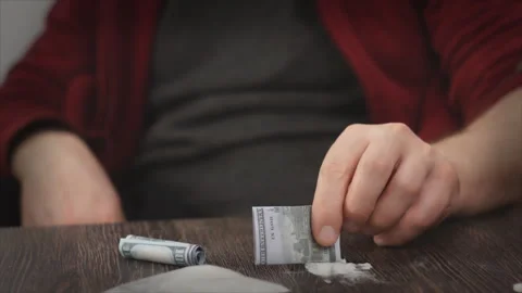 Addicted caucasian man with methamphetamine or cocaine. Stock Footage 98843086