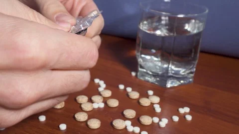 Addicted man nervously extracting lots of pills Stock Footage 99732393