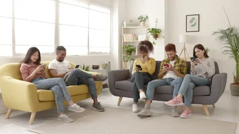 Addicted young friends using smart mobile phones relaxing at home Stock Footage 194513765