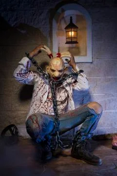 Addiction, Man chained with blood and knife, has a severed leg blood Stock Photos