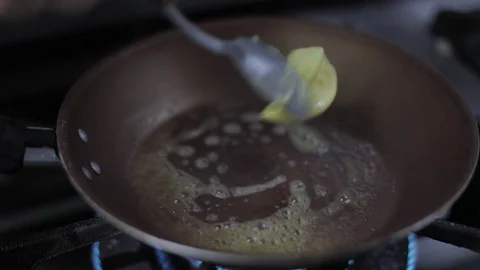 Adding and Melting Butter on Hot Pan Stock Footage 129327289