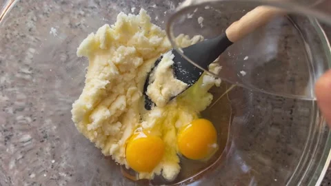 Adding and Mixing Eggs into Butter and Sugar Mixture for Baking Stock Footage 345522283