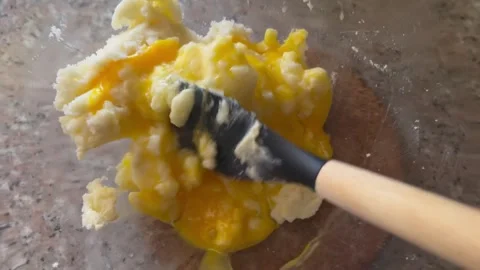 Adding and Mixing Eggs into Butter and Sugar Mixture for Baking 스톡 동영상 345522292