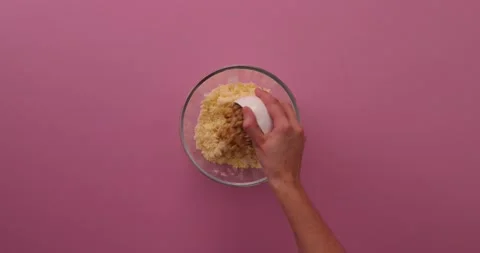 Adding and mixing nuts and cinnamon with butter mixture Stock-Footage 132208658