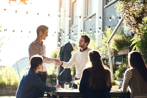 Adding another asset to their team. colleagues shaking hands during a meeting at Stock Photos