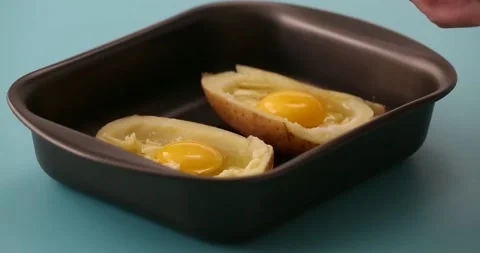 Adding bacon bits to eggs, cheese, in a potato halves 2 Stock Footage 132149130