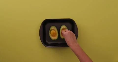 Adding bacon to eggs and avocado 1 Stock Footage 132149567