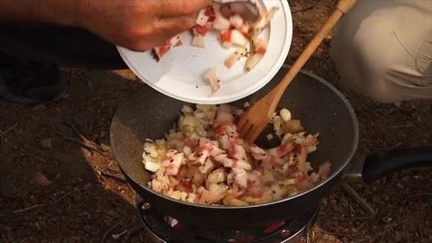 Adding bacon to a hot pan Stock Footage 108310565