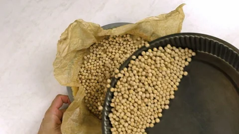 Adding baking beans in pastry case Stock Footage 100231871