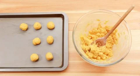 Adding balls of cookie dough to a baking sheet Stock Photos