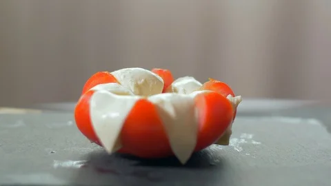 Adding basil to the Caprese  Salad. Black background Stock Footage 109269220