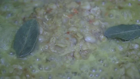 Adding bay leaf and ground black pepper to homemade bean dishes warming up i Vídeos de archivo 222357456