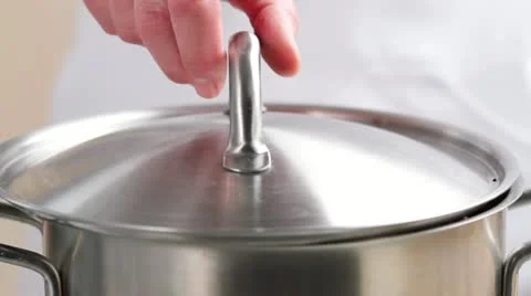 Adding a bay leaf to braised beef Stock Footage 24664015