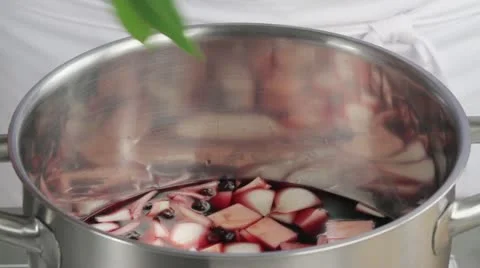 Adding a bay leak to red wine marinade Stock Footage 24666577