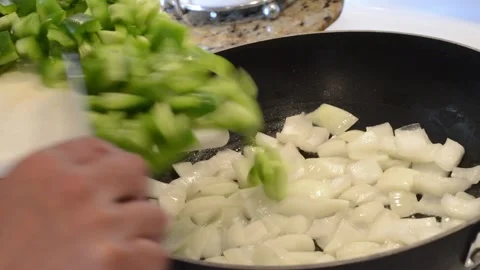 Adding Bell Peppers to the Wok Stock Footage 136059175