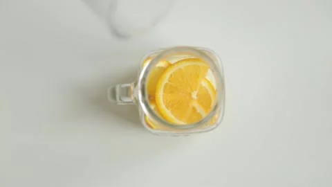 Adding berries and ice to carbonated water. Step by step preparation of cockt Stock Footage 107649975