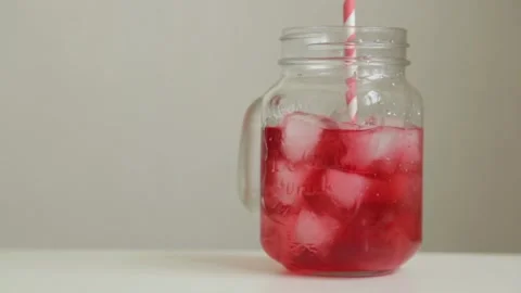 Adding berries and ice to carbonated water. Step by step preparation of cockt Stock Footage 107650143