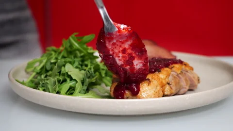 Adding Berry Sauce to Sliced Duck Breast with Arugula. Video stock 346861736