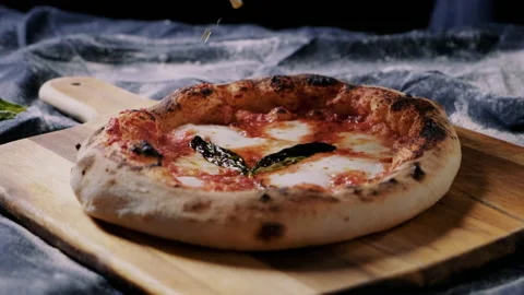 Adding a bit of oil on a delicious freshly baked sourdough pizza Stock Footage 132836062