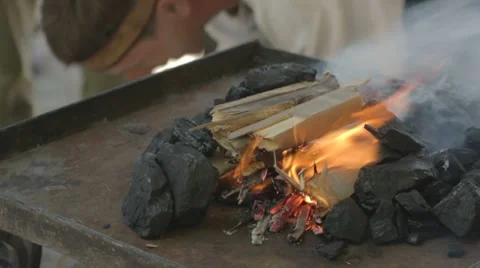 Adding black coal to fire done from paper and wood Stock-Footage 7769239