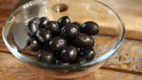 Adding Black Olive into Small Bowl, HD Stock Footage 148190297