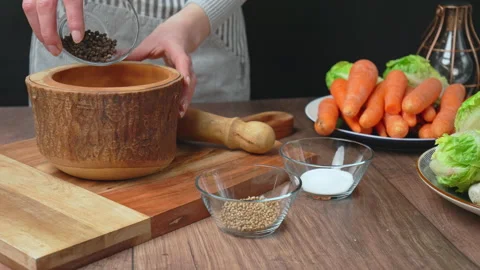 Adding Black Pepper into a pestle and mortar for grinding in 4K. Stock Footage 145103024