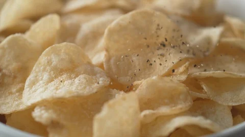 Adding black pepper on potato chips. Slow Motion. Stock Footage 89613768