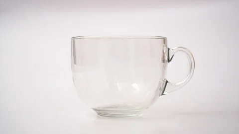 Adding Black Tea in Transparent Cup Stock Footage 125462338
