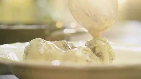 Adding blue cheese cream sauce on a meatballs. Stock Footage 159872099