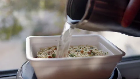 Adding boiling water to the top ramen. Brewing instant noodles Video stock 149222824
