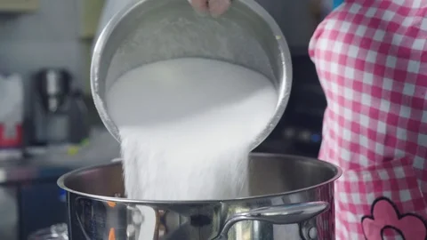 Adding a bowl of sugar into large pot, preparing to make jam Stock Footage 129993412